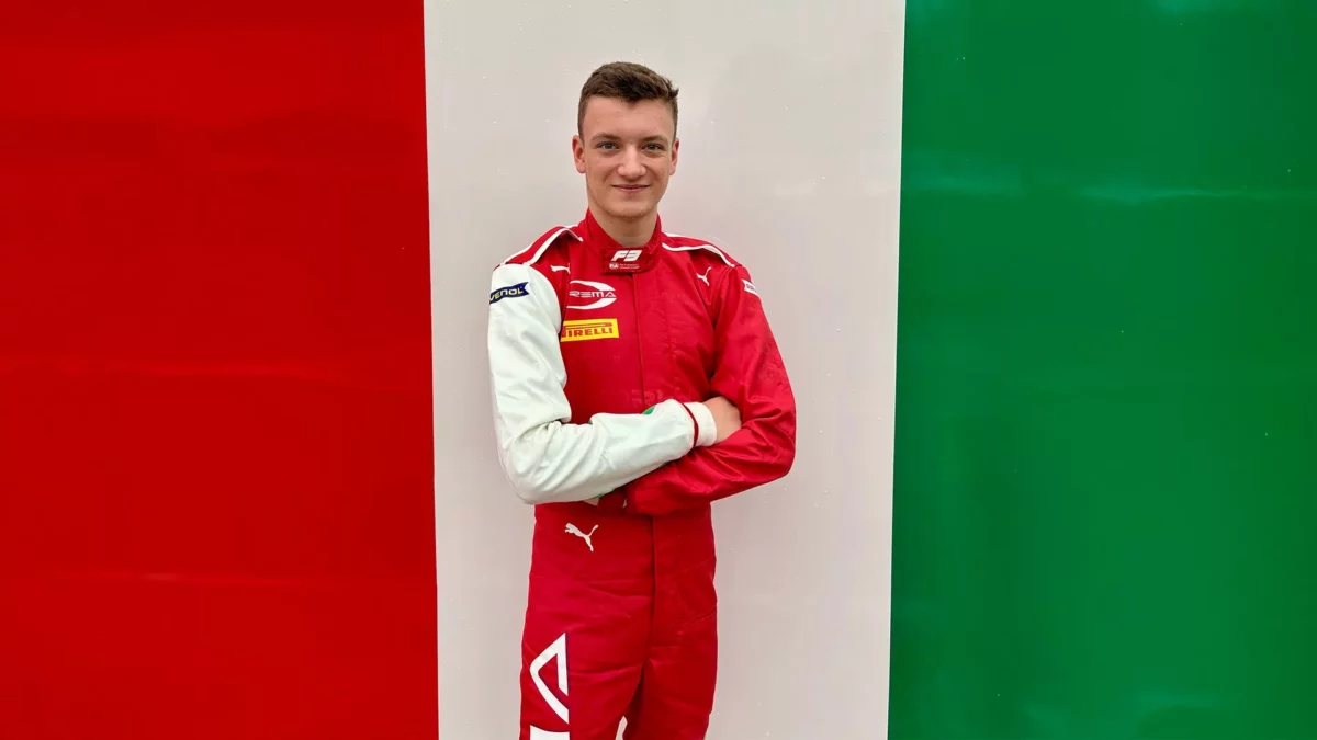 Molnár Martin a PREMA Racing piros versenyoverálljában, olasz trikolór színű fal előtt